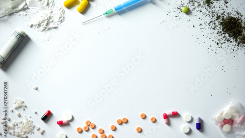 Different drugs and syringe on table, abuse and addiction concept, awareness