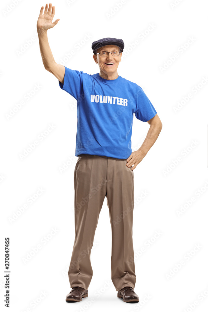 Senior male volunteer waving at the camera Senior male volunteer waving at the camera