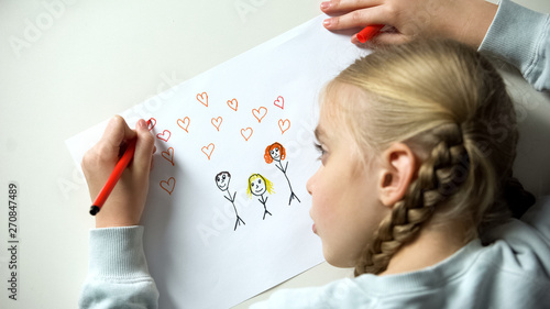 Принти на полотні Little girl painting family with heart signs, orphan dreaming about parents