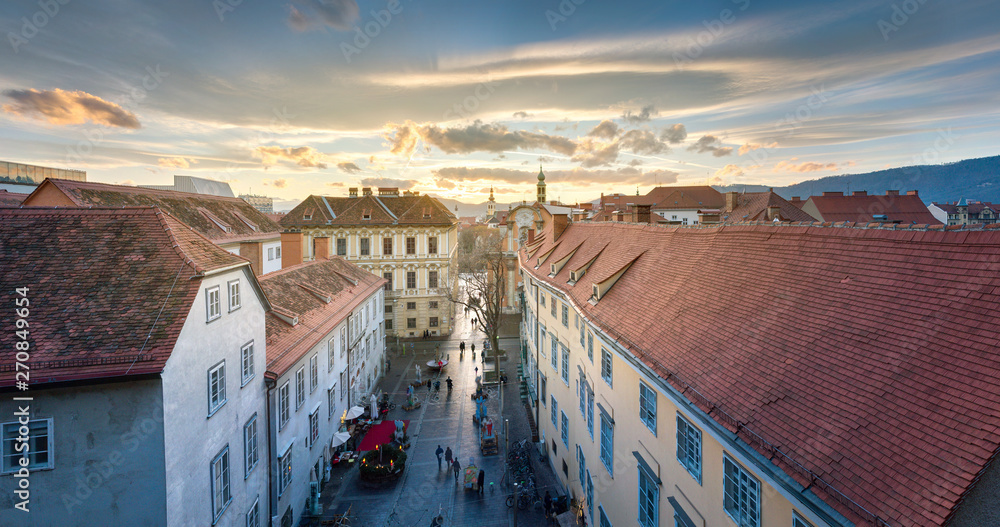 GRAZ, AUSTRIA: View of traditional roofs at sunset in winter.