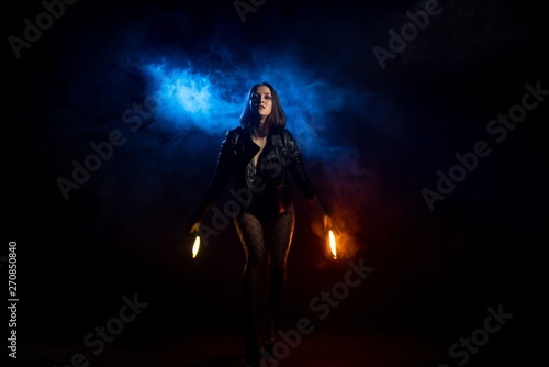 Brunette in black jacket with torches shot