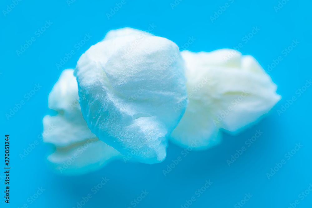 Popcorn on a blue background. Macro image of popcorn Popcorn on a blue background. Macro image of popcorn