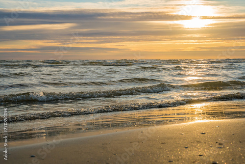 Fototapeta Naklejka Na Ścianę i Meble -    Very beautiful golden sunset on the sea, golden waves and the golden coast.