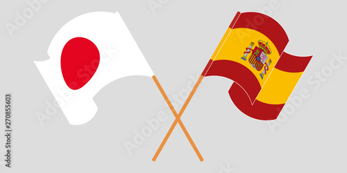 Crossed and waving flags of Spain and Japan