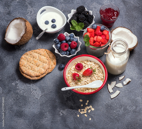 Healthy vegan breakfast with coconut yogurt, muesli, chia pudding, crisp bread, nuts, berries. Balanced diet and healthy eating concept