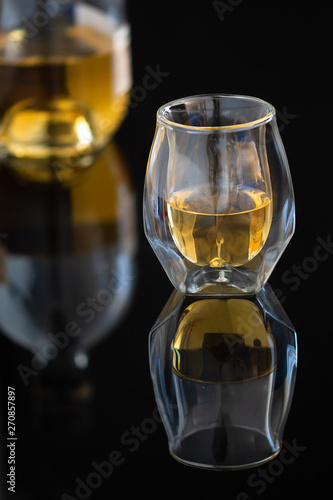 Whiskey glass on black background
