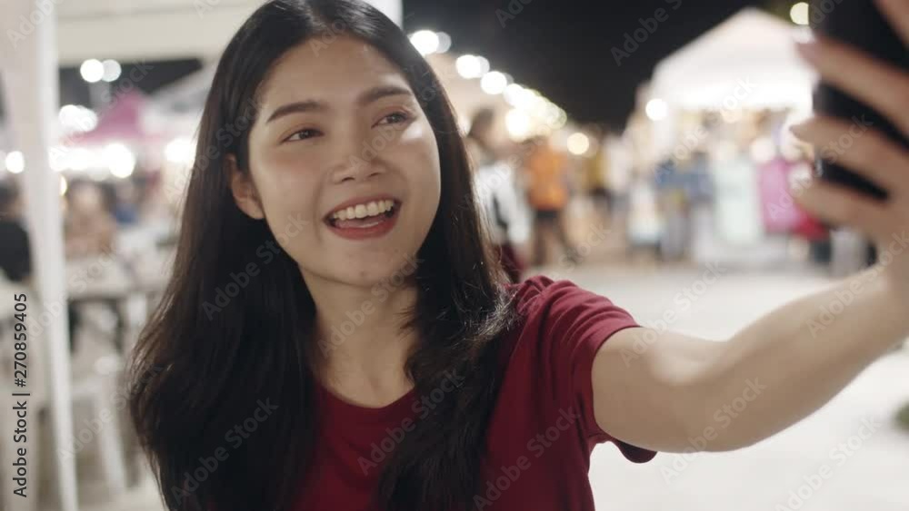 Traveler Asian blogger women travel in Bangkok, Thailand, beautiful female using mobile phone make vlog and live in social media at Khao San Road. Women travel in Thailand concept. Slow motion shot. Traveler Asian blogger women travel in Bangkok, Thailand, beautiful female using mobile phone make vlog and live in social media at Khao San Road. Women travel in Thailand concept. Slow motion shot.