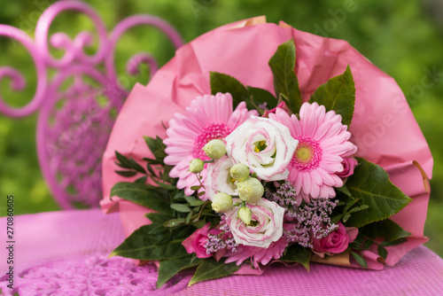 Pink flower bouquet on a garden chair