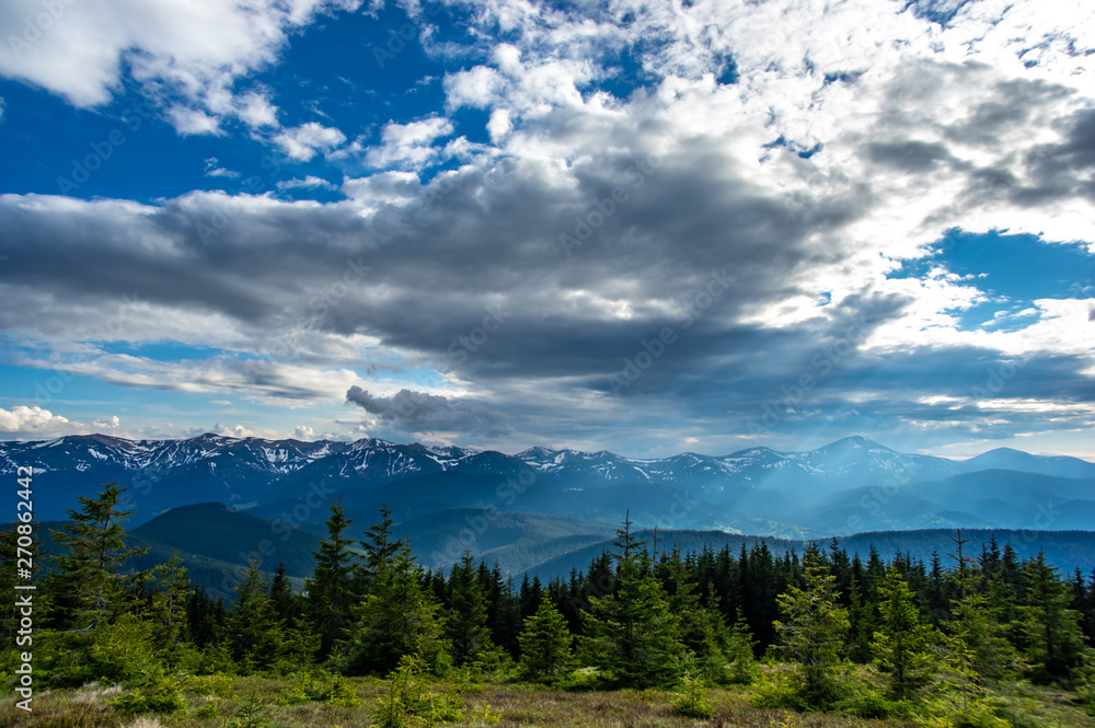 The sun and clouds over the ridge