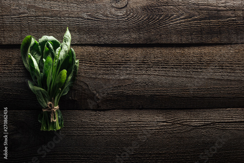 top view of green spinach leaves on wooden rustic table