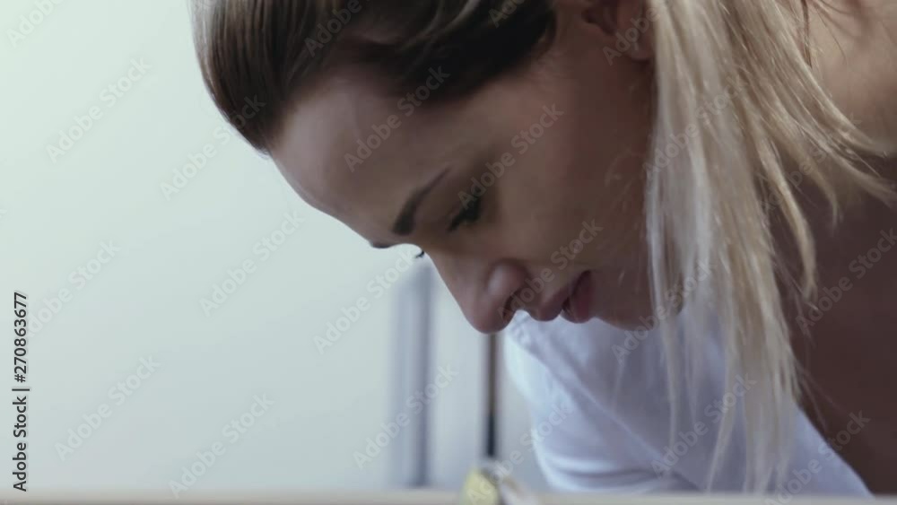 A young mother is looking at her little baby boy in cradle. A young mother is looking at her little baby boy in cradle.