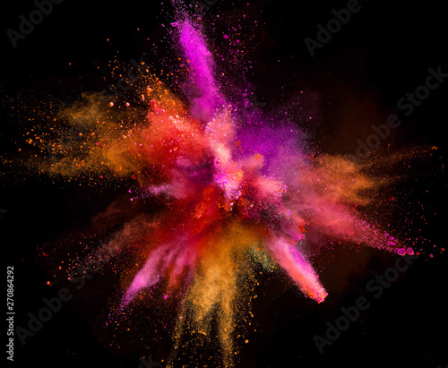 Colored powder explosion on black background. Freeze motion.