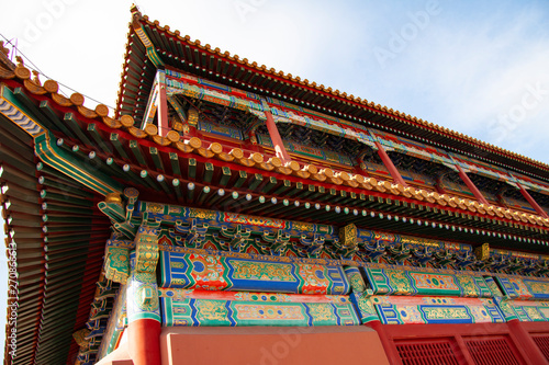 Impressive colorful elaborate roof from the forbidden city in Beijing, China. The colors of the roofs, roofing materials and roofing are filled with symbols.