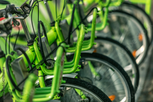 City bicycle parking with many green bicycles © proimagecontent
