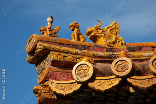 Chinese imperial roof decoration or roof charms, or roof figures with emperor and creatures in the Forbidden City in Beijing, China.