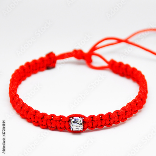 delicate decorative bracelet woven from red rope.