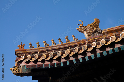 Chinese imperial roof decoration or roof charms, or roof figures with emperor and creatures in the Forbidden City in Beijing, China. © Ole