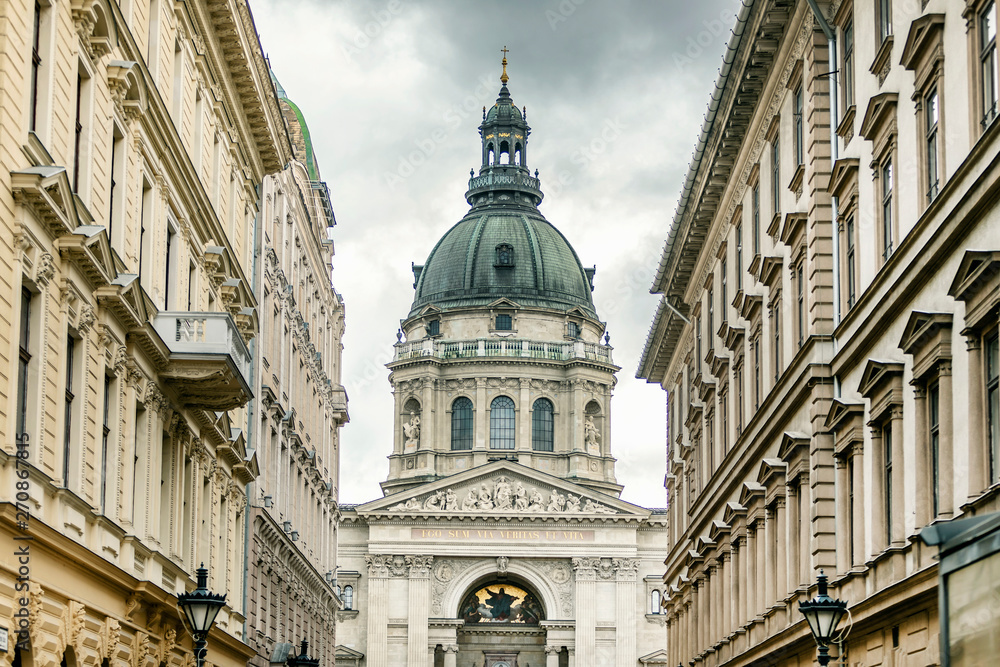 Close up street view of Budapest St. Stephen's Basilica standing between the houses