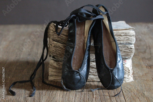 vintage black ballet shoes and old books