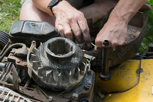 Man repairing an old lawn mower