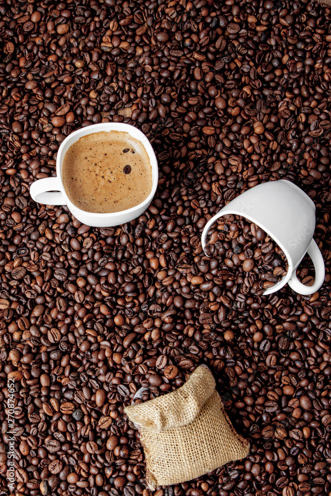 Naklejka premium Coffee cup with coffee bag on wooden table. View from top