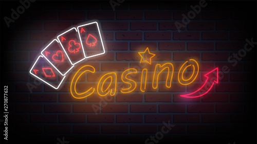 Neon sign "Casino" and playing cards on break wall