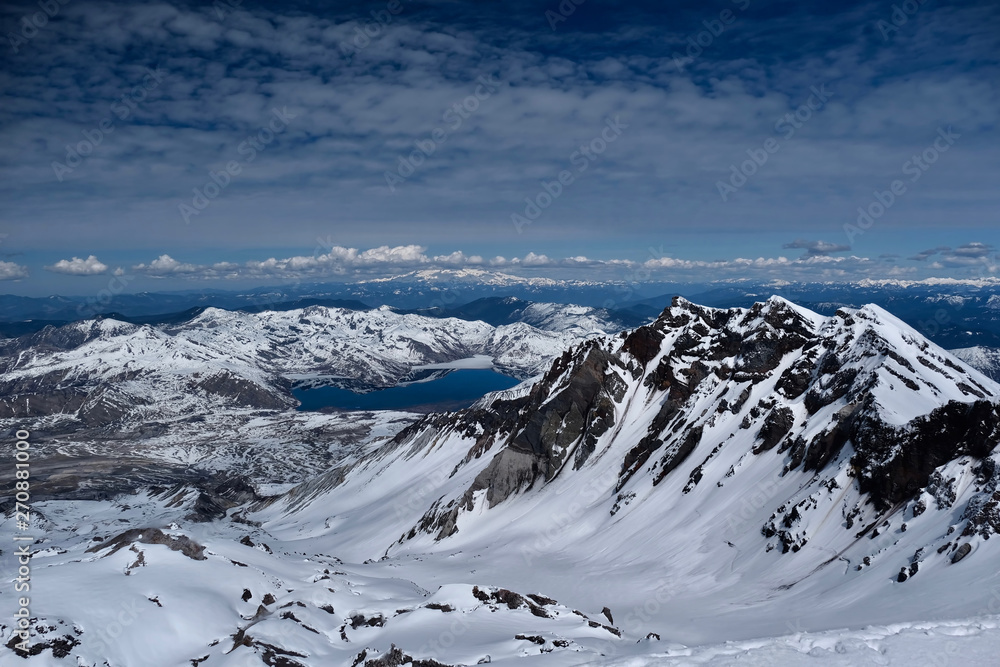 Obraz premium Panoramic view of Mount St Helens crater with Spirit lake and Mount Rainier in distance. Mount St Helens National Volcanic Monument. Washington. United States of America.