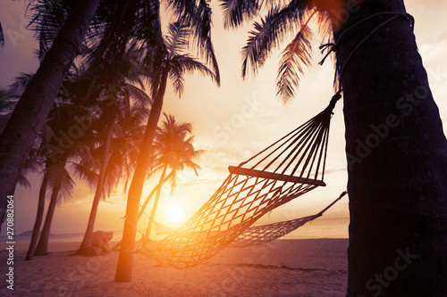 silhouette of hammock at sunset on the beach © kamonrat