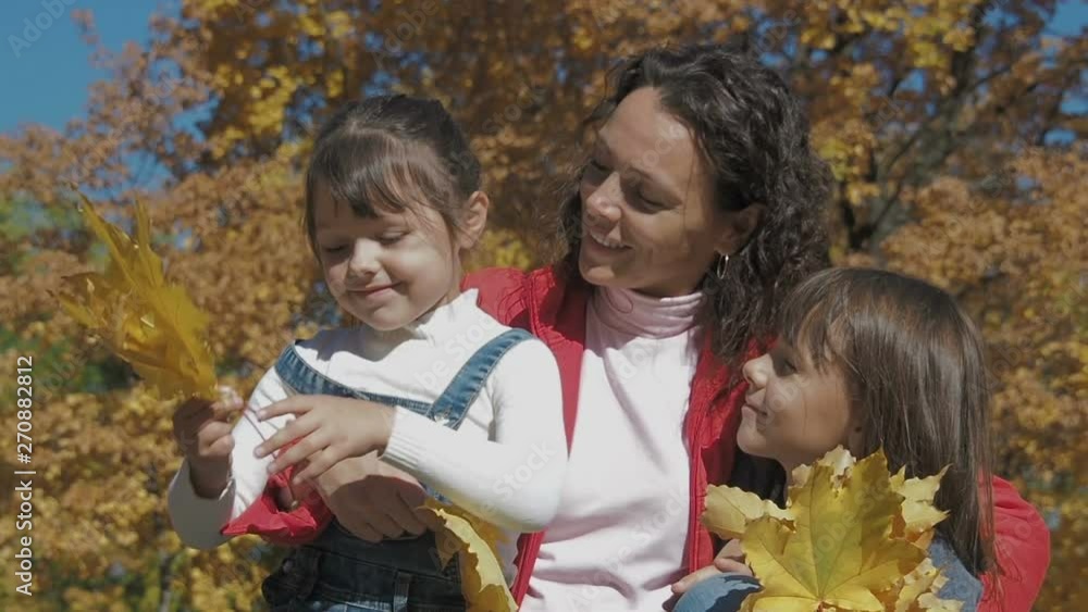 Happy family in autumn park. Portrait of a happy mom with her daughter in the fall in nature. Happy family in autumn park. Portrait of a happy mom with her daughter in the fall in nature.