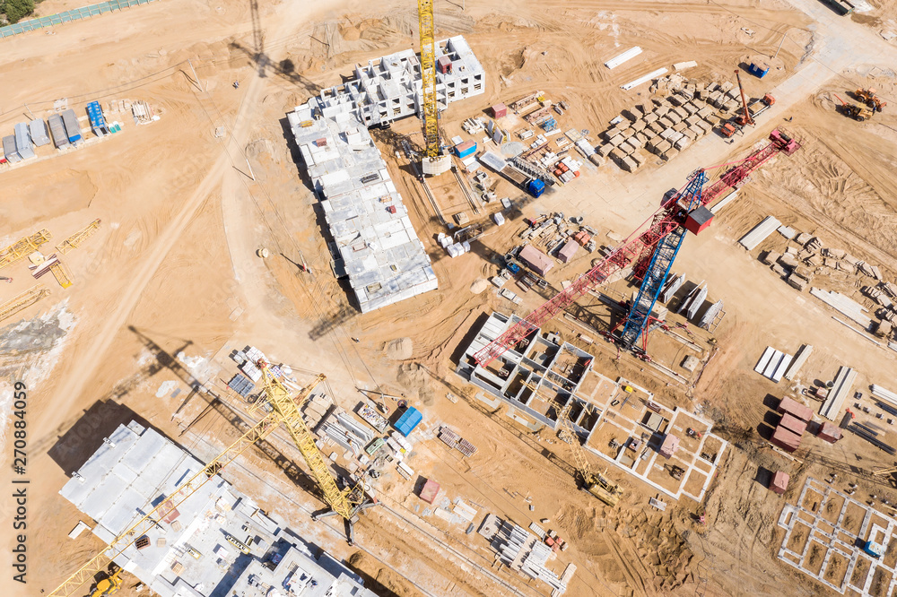 Naklejka premium aerial top view of city construction site. building of new apartment complex. drone image.