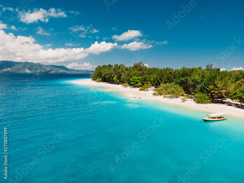 Tropical beach with white sand and turquoise ocean. Aerial view. Paradise holiday place
