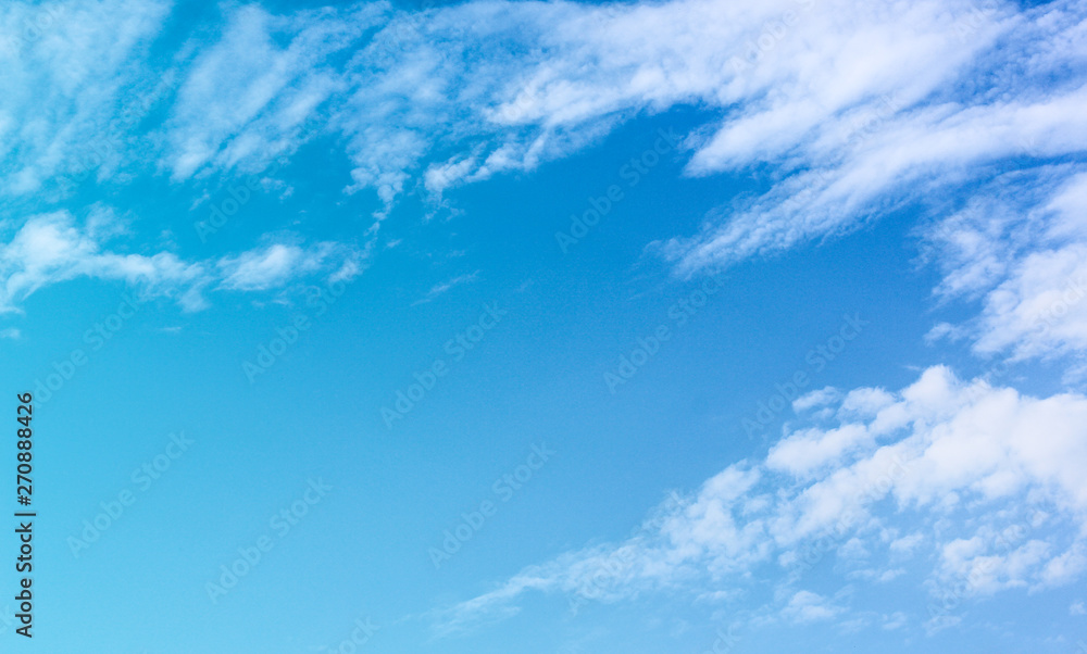 Obraz premium Bright blue sky background with white clouds group patterns and copy space