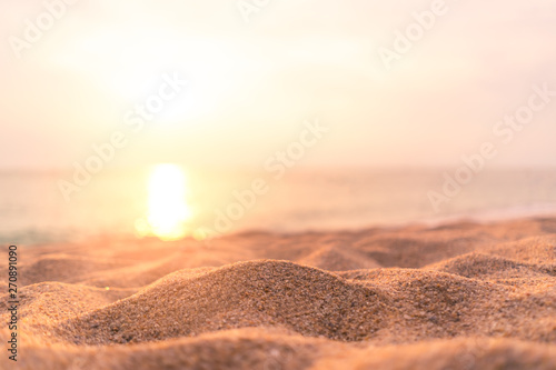 Copy space of soft sand sea and blur tropical beach with sunset sky and cloud abstract background. © tonktiti