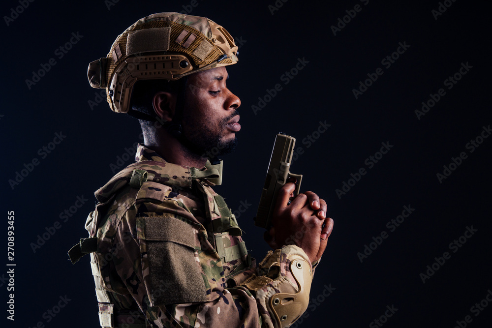 american man in camouflage suit aiming with a pistol studio shot american man in camouflage suit aiming with a pistol studio shot