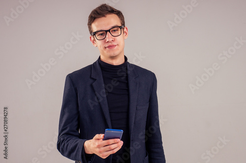 Fotografie fashion man asymmetric facial features ears holding smartphone wearing glasses i