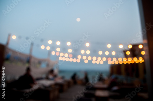 Blur mode of restaurant near the sea in evening time with bokeh background 