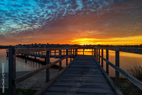 Winding, long jetty at Sunset, with colorful sky
