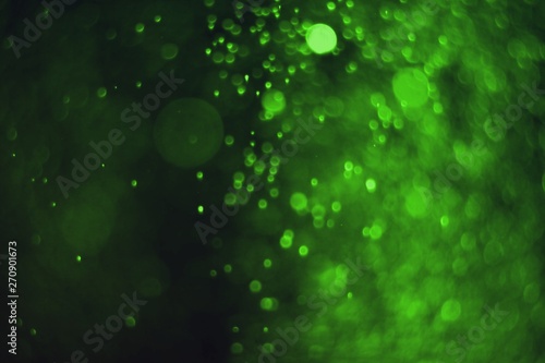 green a lot of falling glitter one color bokeh texture - fantastic abstract photo background