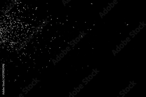 White falling particles round shape on black backround.Glowing blizzard. Scatter falling round particles.