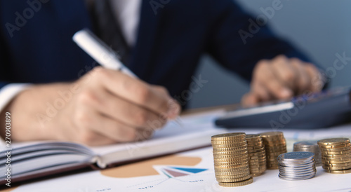 Businessman or accountant working on a calculator to calculate the concept of commercial data, Accounting, business concept