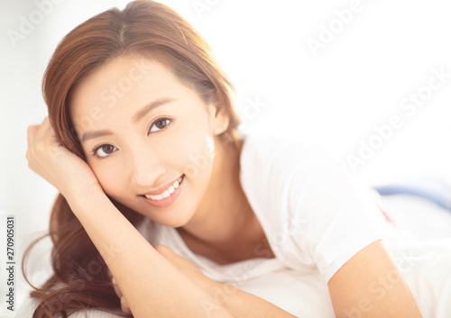 closeup young asian smiling woman on bed