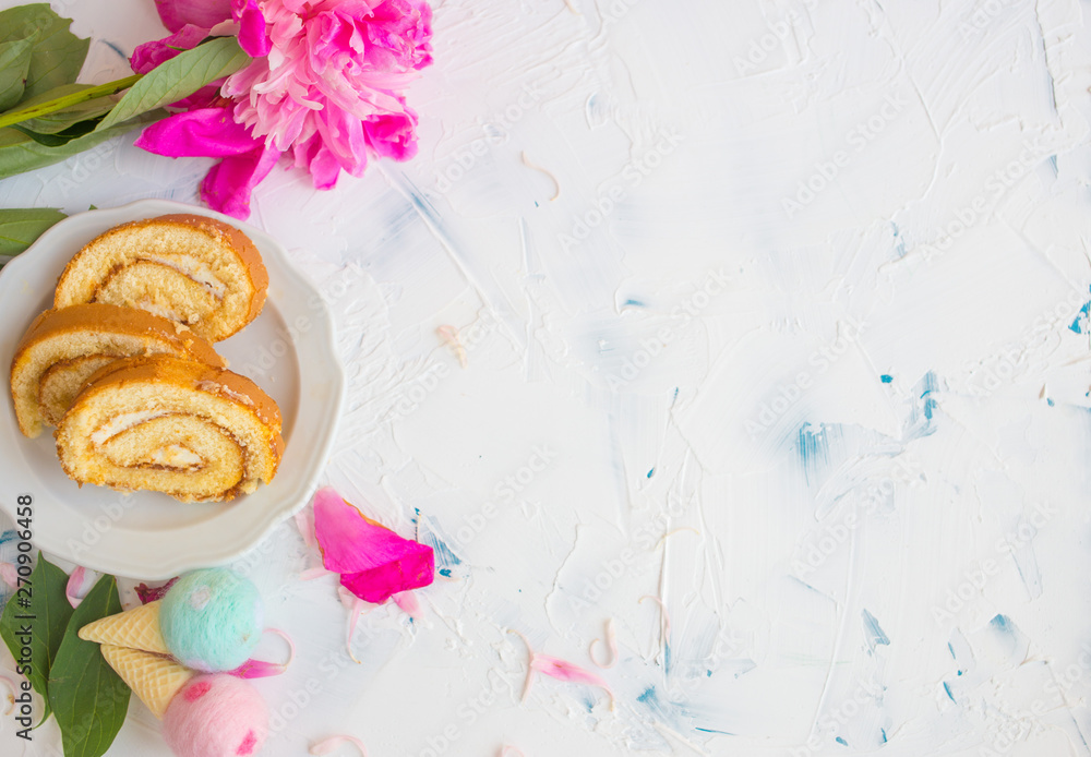 Sweet cake on a white background with pink peony. Romantic breakfast. Woman's desk at work Sweet cake on a white background with pink peony. Romantic breakfast. Woman's desk at work