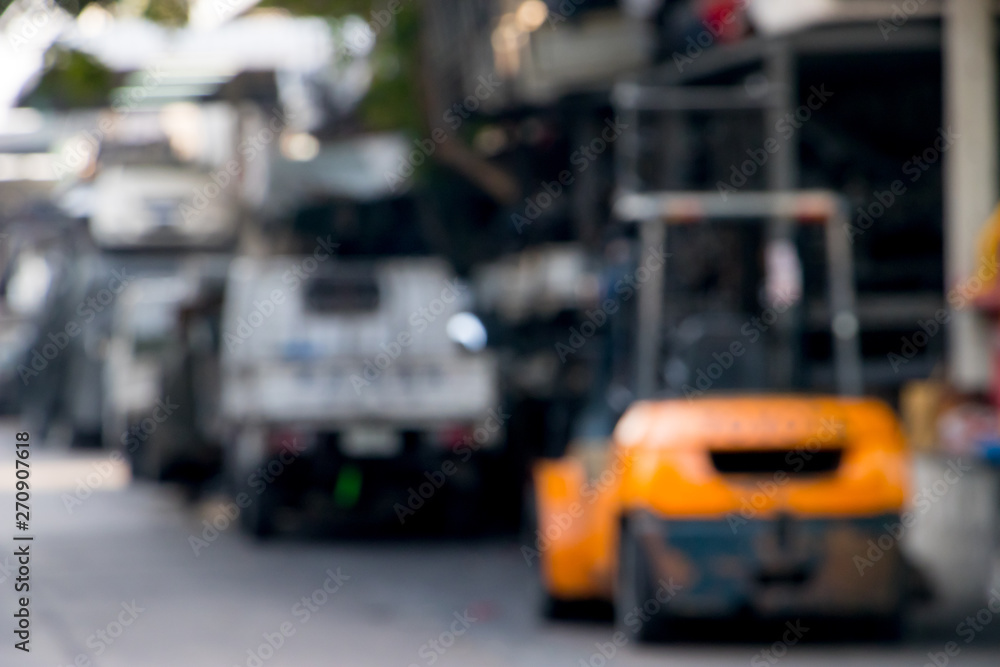 Blurry forklift truck on market autoparts.