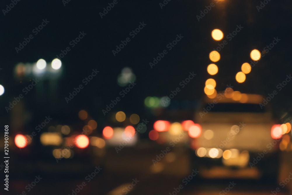 Abstract blurry traffic road bokeh light view from inside a car.