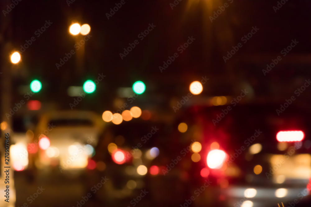 Abstract blurry traffic road bokeh light view from inside a car.