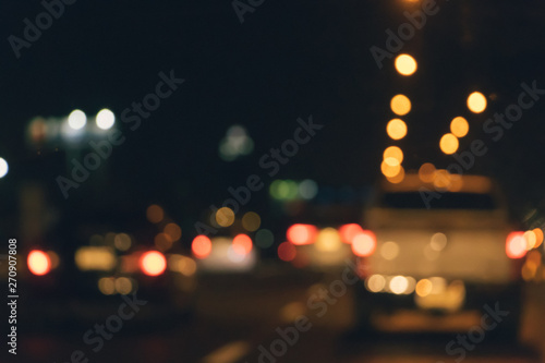 Abstract blurry traffic road bokeh light view from inside a car.