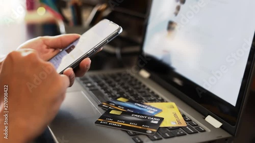 A man online shopping at home using credit card and laptop for online shopping, technology and internet concept