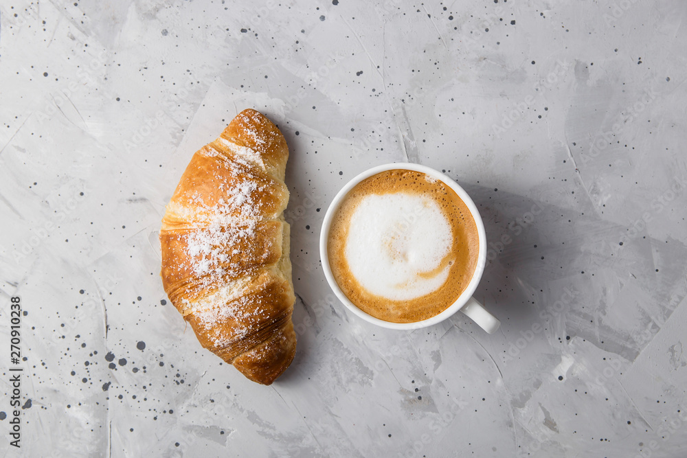 Fotografie Beautiful and simple traditional French breakfast of fresh croissant and a cup o