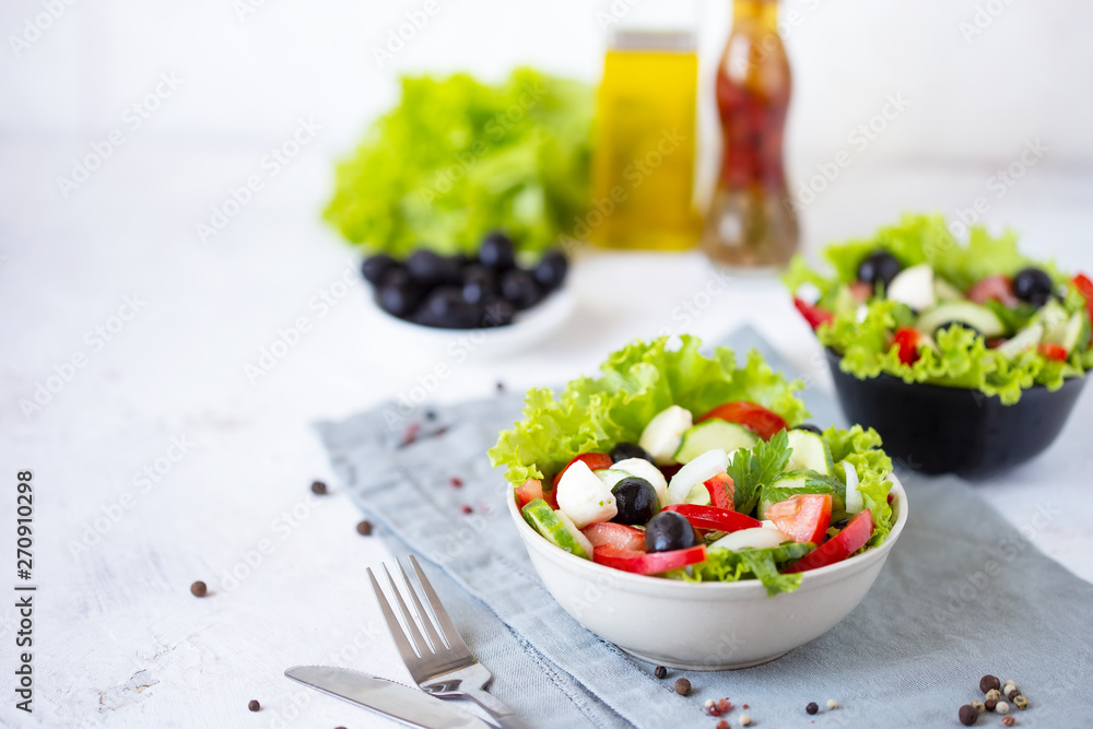 Appetizing greek salad in a plate on a served table Appetizing greek salad in a plate on a served table