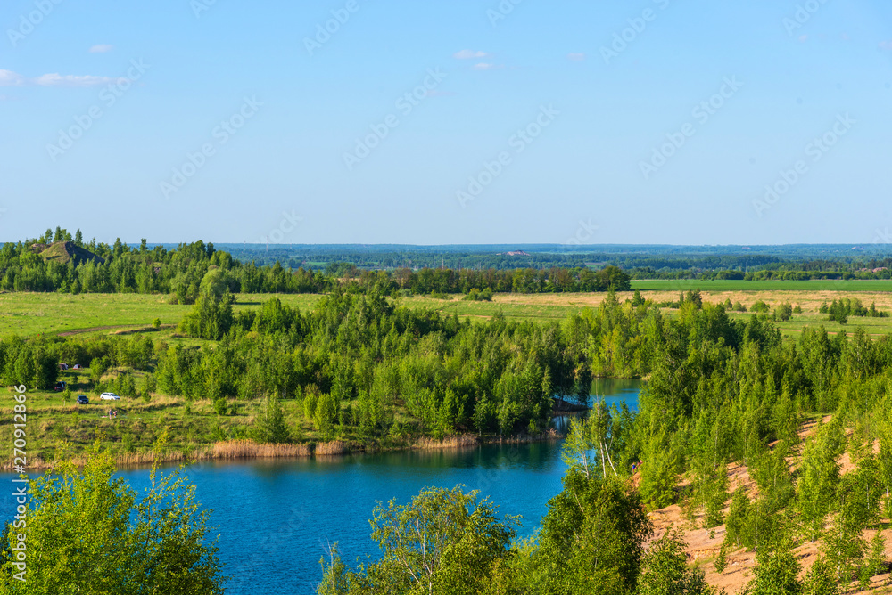 Aerial view of picturesque hills and blue lakes in Konduki, Tula region, Russia. Turquoise quarry in Romantsevo. Aerial view of picturesque hills and blue lakes in Konduki, Tula region, Russia. Turquoise quarry in Romantsevo.